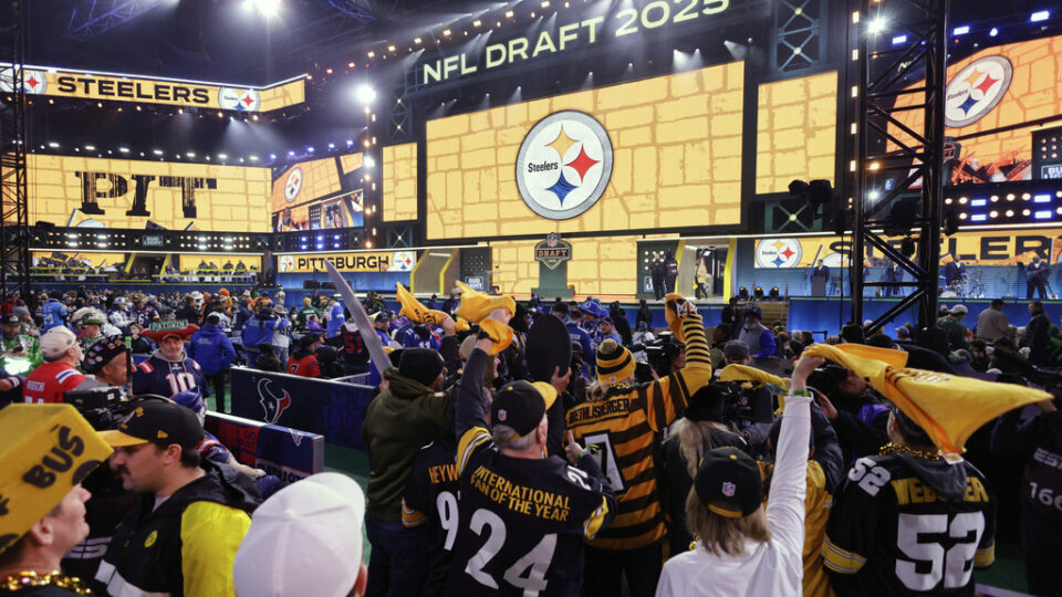 Excitement and cheers in a scene from the NFL Draft room in 2025